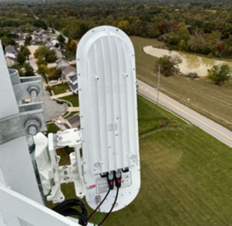 A technician installing a Taara light-beam terminal on a communications tower.